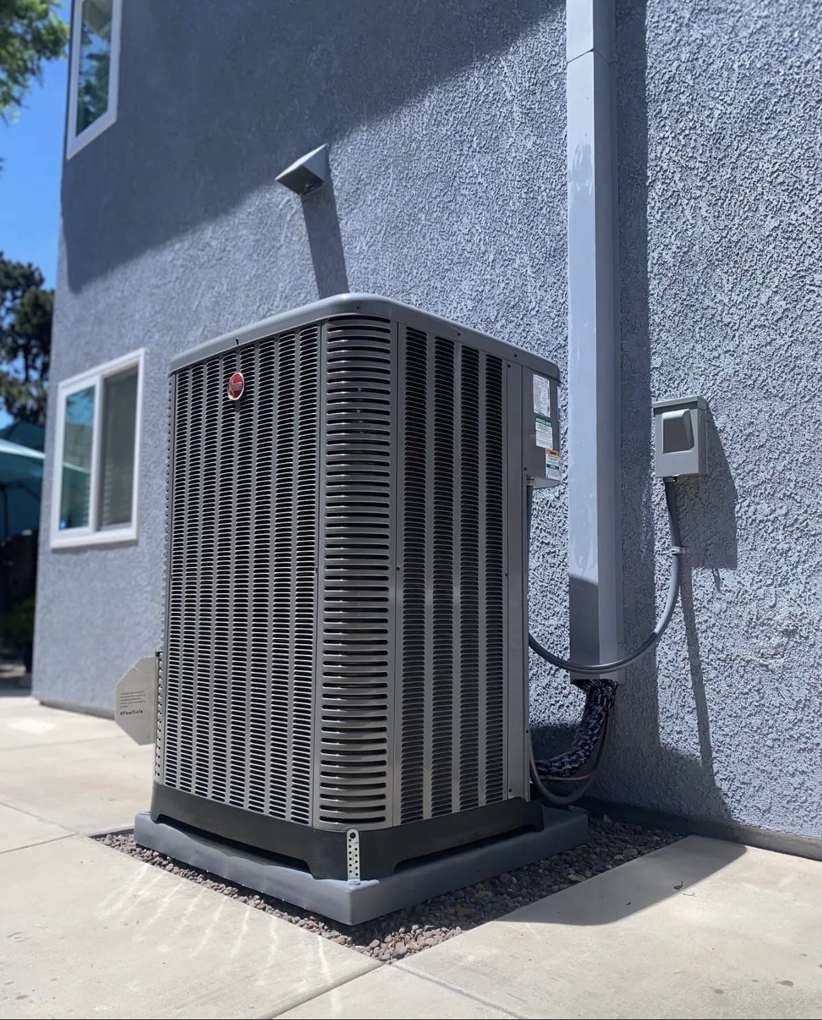New Rheem A/C condenser on a composite pad installed by Rescue