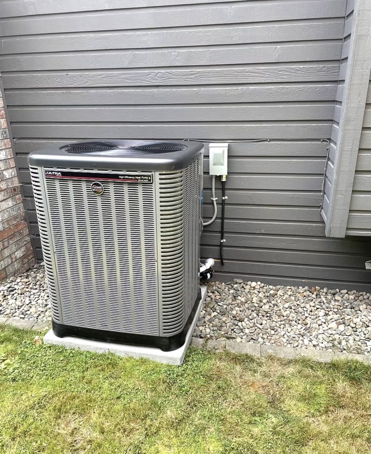 Rheem Ultra high-efficiency heat pump installed on a raised pad