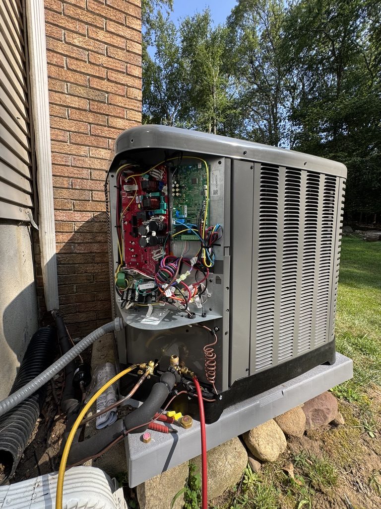 Rescue technician performing board-level diagnostics on a condenser